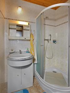 a bathroom with a sink and a shower at Pension Villa Hany in Mariánské Lázně