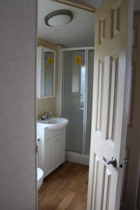 a bathroom with a sink and a toilet at 2 Bed Static Caravan @ Hoburne Devon Bay in Paignton
