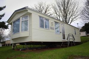 a tiny house on display in a yard at 2 Bed Static Caravan @ Hoburne Devon Bay in Paignton