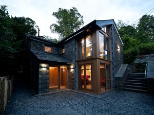 a house with glass doors on the side of it at Cedar Manor in Windermere