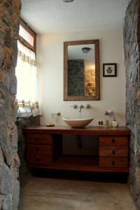 a bathroom with a sink and a mirror at Casa de Piedra in Potrerillos