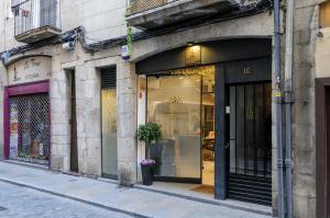 a store front with glass doors on a city street at Old Side Girona One in Girona +16 photos