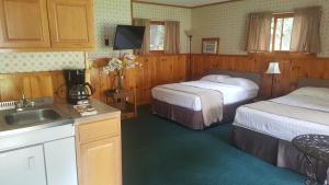 a hotel room with two beds and a sink at The Meadows in Lake George