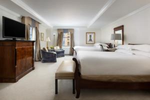 a hotel room with two beds and a flat screen tv at Michelangelo Hotel in New York