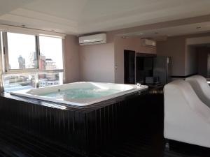 uma grande banheira num quarto de hotel em Apart Belgrano em Posadas