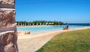 a group of people standing next to a swimming pool at Camping Villaggio Lamaforca in Torre Santa Sabina