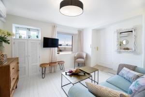 a living room with a blue couch and a table at "NEW" Deluxe designer Villa Infinity, with Panoramic sea views,own exclusive heated private pool, subtropical gardens in Tías