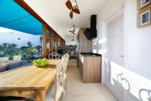 a kitchen and dining room with a wooden table at "NEW" Deluxe designer Villa Infinity, with Panoramic sea views,own exclusive heated private pool, subtropical gardens in Tías