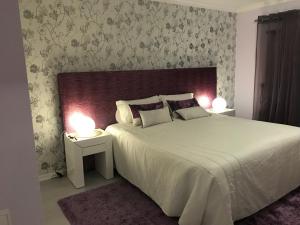a bedroom with a large white bed with two lamps at Timeless Vacations Vilamoura Marina Flat WIFI & Pool in Vilamoura +58 photos