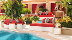 a hotel lobby with a red couch and a pool at Encore at Wynn Las Vegas in Las Vegas