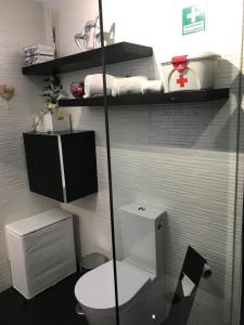 a bathroom with a white toilet in a room at Timeless Vacations Vilamoura Marina Flat WIFI & Pool in Vilamoura