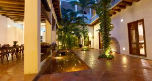 a large room with a pond with plants in it at Hotel Quadrifolio in Cartagena de Indias