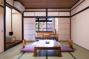 a living room filled with furniture and a table at Nikko Tokanso in Nikko