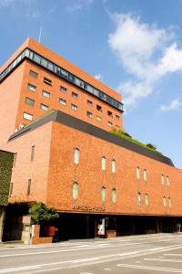 a large brick building with a street in front of it at Hachinohe Grand Hotel in Hachinohe
