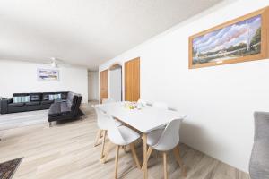 a living room with a white dining room table and chairs at Breakers 3 - linen not included in Forster +7 photos