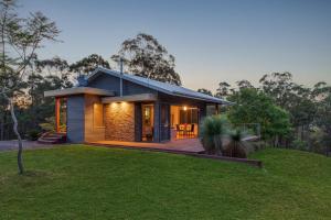 a house on a hill with a green yard at Cedars Mount View (Adults Only) in Mount View