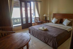 Postel nebo postele na pokoji v ubytování Ubud Canti House