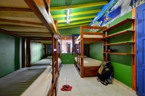 a room with two bunk beds and a desk at The Wandering Paisa in Medellín