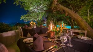 a table set up for a meal under a tree at The Lady Hill Hotel in Galle