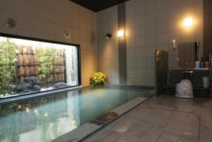 a large swimming pool in a room with at Hotel Route-Inn Ishioka in Ishioka