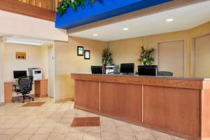a lobby with a reception desk with two computers at Days Inn & Suites by Wyndham Thompson in Thompson