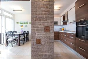 a kitchen and dining room with a brick wall at Luxury apartment SEA in Pula