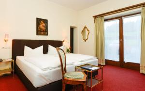 Postel nebo postele na pokoji v ubytování Stoll's Hotel Alpina