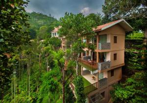 an apartment building in the middle of the forest at Oxygen Resorts Thekkady in Thekkady