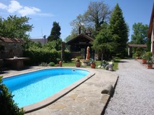 a swimming pool in the yard of a house at Penzion Prezident in Soběraz