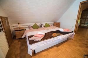 a bedroom with a large bed in a attic at Apartment Tina with Seasonal Pool in Podsreda