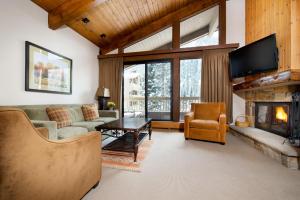 a living room with a couch and a fireplace at The Gant in Aspen