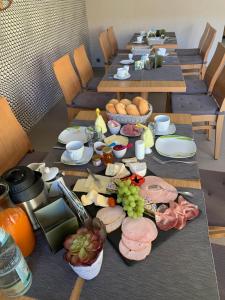 a long table with plates of food on it at landpension-dette in Berlingerode