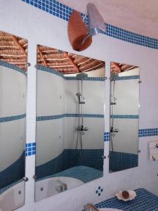 a bathroom with a shower and a tub and a sink at Hôtel Safari Vezo Anakao in Anakao