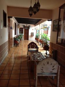 a hallway with chairs and tables in a building at Hotel Regis in Uruapan del Progreso