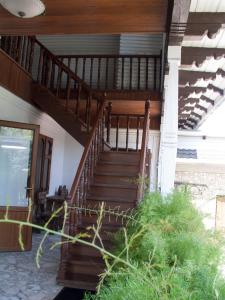 a wooden staircase leading up to a house at Conacul Pitusca in Pituşca