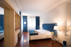 Voodi või voodid majutusasutuse Hotel Brescia toas
