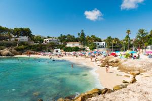 a beach with a bunch of people in the water at ACAN0306 in Calpe