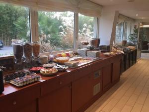 a kitchen filled with lots of different types of food at Hotel SPA Plage St Jean in La Ciotat