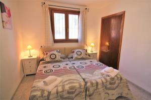 a bedroom with a large bed with pillows and a window at ACAN0306 in Calpe +21 photos