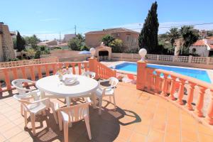 a patio with a table and chairs next to a pool at ACAN0306 in Calpe