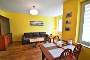 a living room with a couch and a table at ApartamentyPrzyMorzu Zielone Tarasy in Kołobrzeg