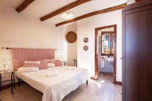 1 dormitorio con 1 cama blanca grande en una habitación en Domu Ala - ByNos Homes en Baunei