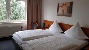 Postel nebo postele na pokoji v ubytování Hotel Walz