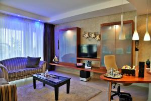 a living room with a couch and a table at BON Hotel Waterfront Richards Bay in Richards Bay