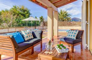 a patio with two couches and a table at Can Gelaberts by Sealand Villas in Muro