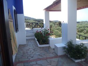 a view from the door of a house with a balcony at Ilis Villas in Kyllini