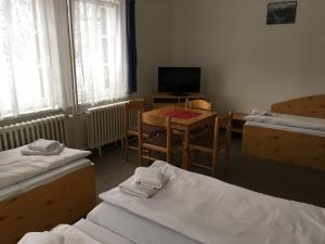 Postel nebo postele na pokoji v ubytování Hotel Tři Růže