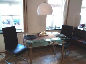 einen Esstisch mit 2 Stühlen und einer Lampe in der Unterkunft Ferienwohnung Graul in Wernigerode