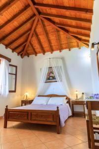 a bedroom with a bed and a wooden ceiling at Anatoli Villa in Steni Vala Alonissos