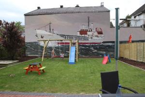 a mural of a cruise ship with children playing on a playground at KAJÜTE in Brake